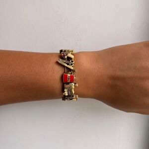 GOLD TONE NAIL SALON THEMED SLIDING CHARM BRACELET
